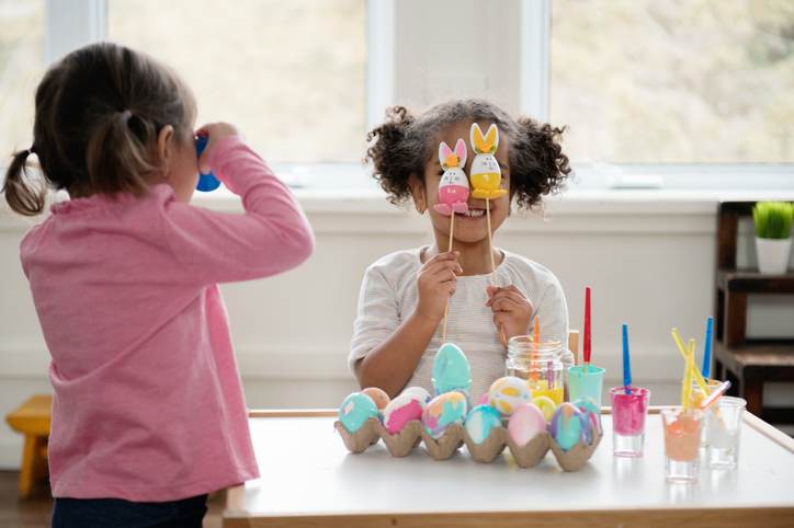 Two Little girls looking through Easter eggs. Two Little girls looking through Easter eggs.